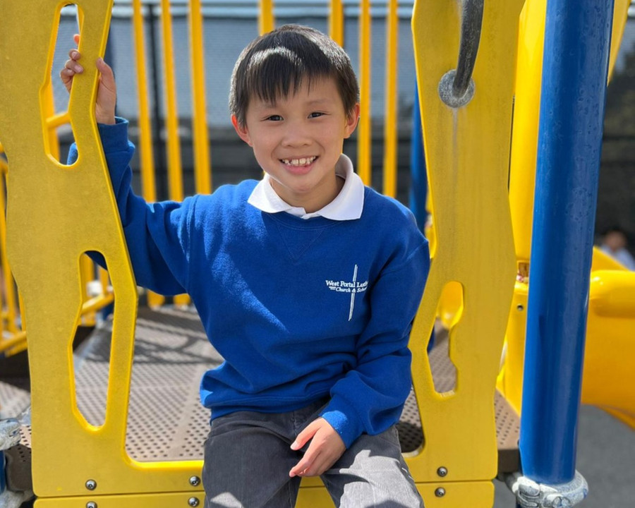 West Portal Lutheran student on playground equipment
